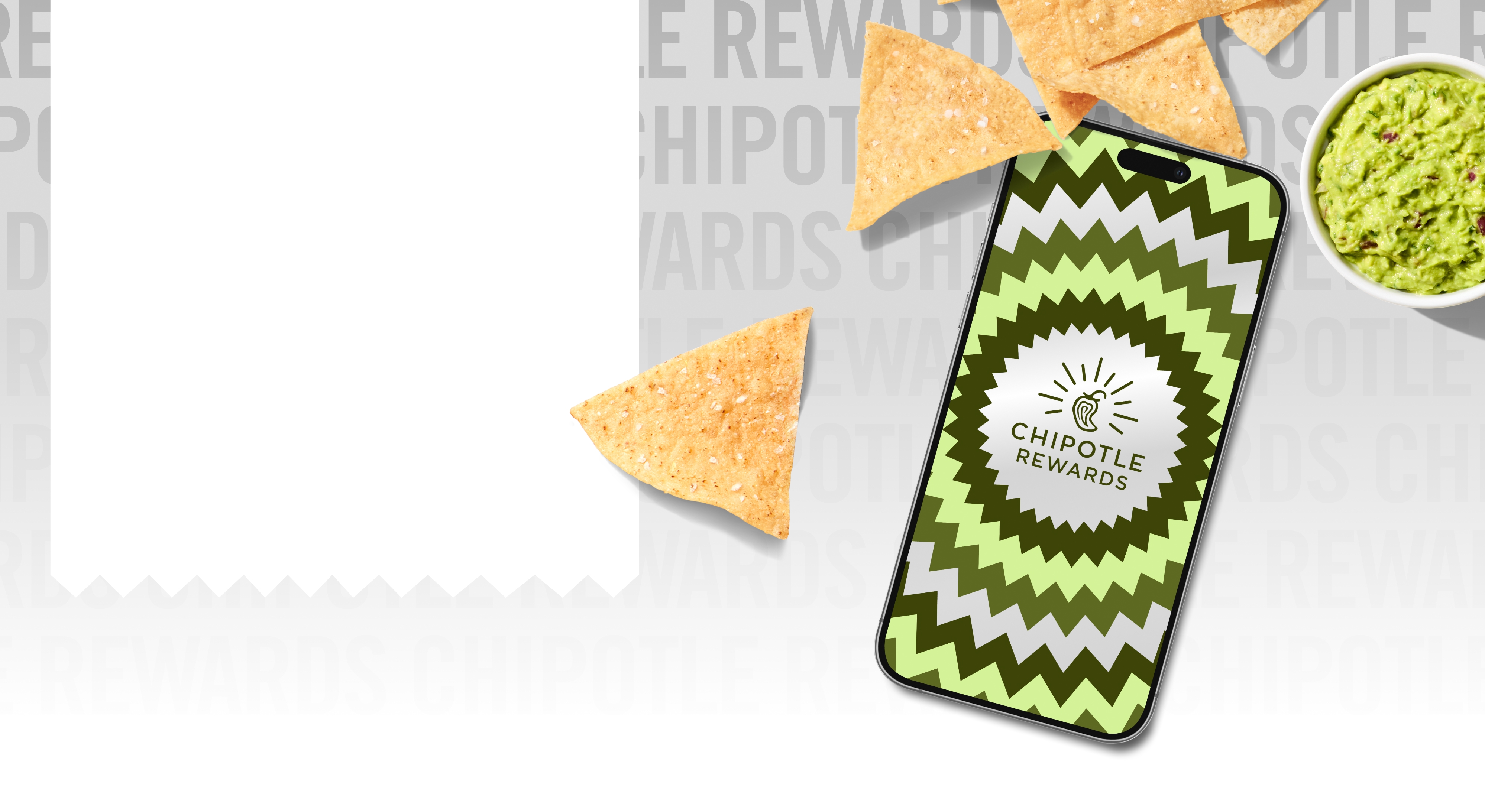 A fresh side of Guac and Tortilla Chips surrounded by a smart phone with Chipotle Rewards branding in green and silver.