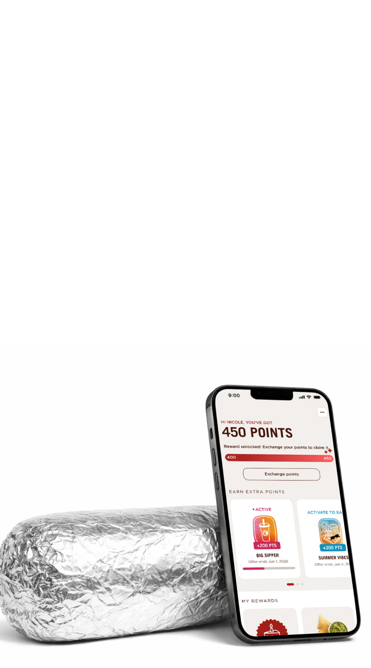 A Chipotle Burrito wrapped in foil behind a smart phone displaying the Chipotle app with a Free Chips reward.